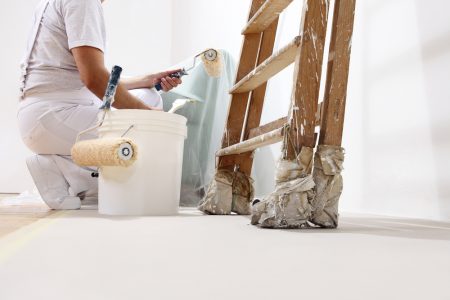 Painter,man,at,work,with,a,roller,,bucket,and,ladder,